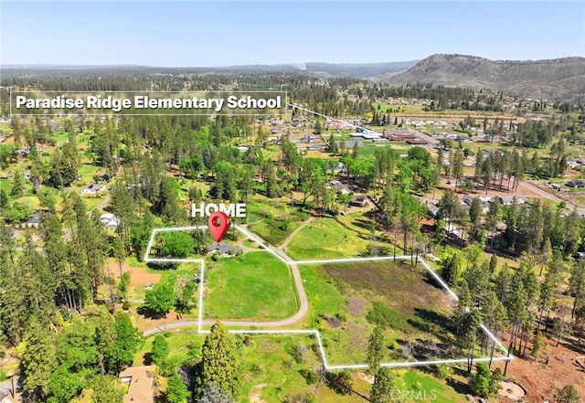 birds eye view of property with a mountain view