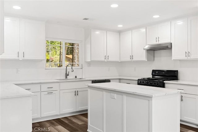 kitchen with a sink, dark wood finished floors, black gas range, recessed lighting, and under cabinet range hood