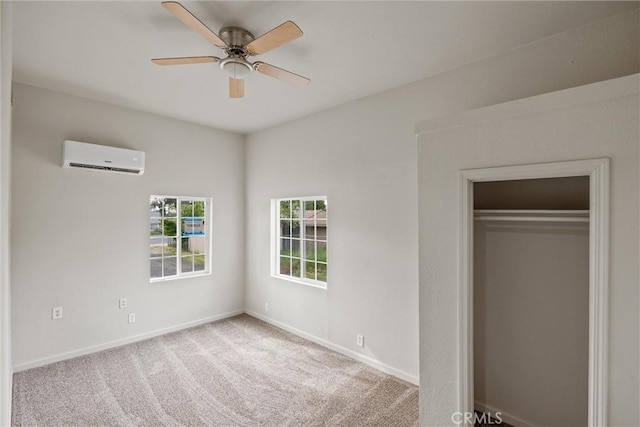 unfurnished bedroom with baseboards, a closet, a wall mounted air conditioner, carpet floors, and ceiling fan