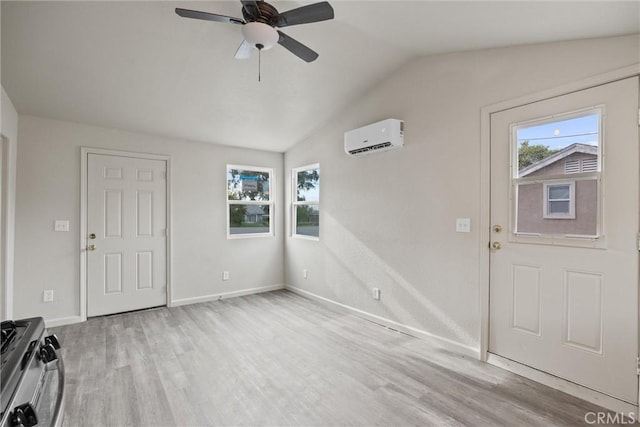 entrance foyer with a ceiling fan, wood finished floors, an AC wall unit, lofted ceiling, and baseboards