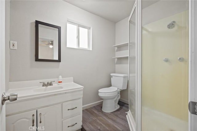 full bathroom with a shower stall, vanity, toilet, and wood finished floors