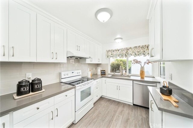 kitchen with dishwasher, a sink, electric stove, under cabinet range hood, and white cabinetry