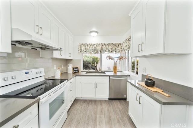 kitchen featuring white cabinets, a sink, under cabinet range hood, white electric range oven, and stainless steel dishwasher