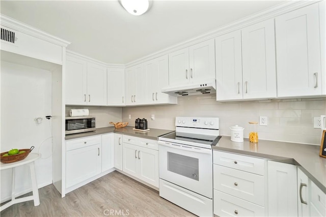 kitchen with stainless steel microwave, white electric stove, white cabinets, under cabinet range hood, and light wood-style floors