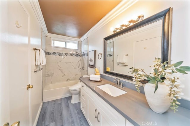 full bath featuring ornamental molding, toilet, tub / shower combination, vanity, and wood finished floors