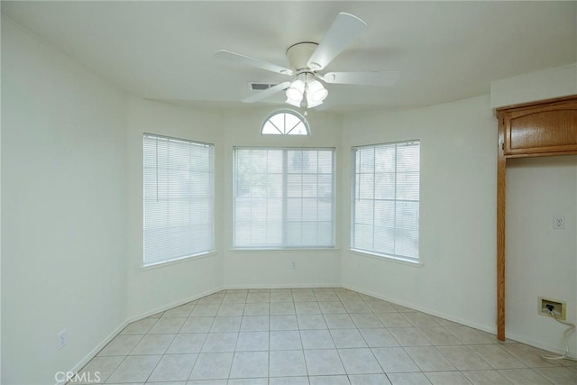 interior space with visible vents, ceiling fan, light tile patterned floors, and baseboards