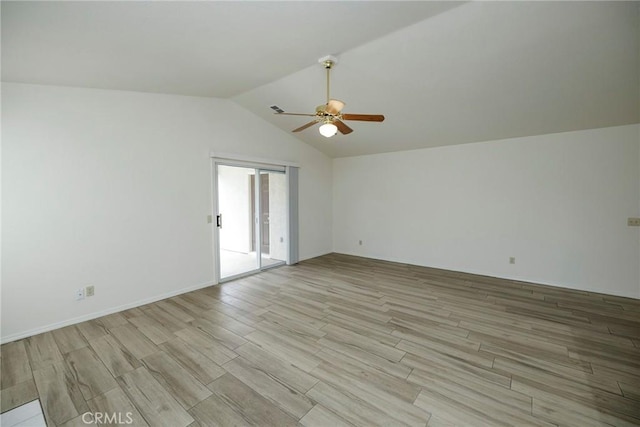 spare room featuring lofted ceiling, light wood-style floors, and ceiling fan