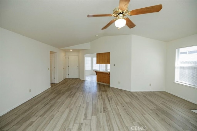 unfurnished living room with light wood-type flooring, baseboards, a ceiling fan, and lofted ceiling