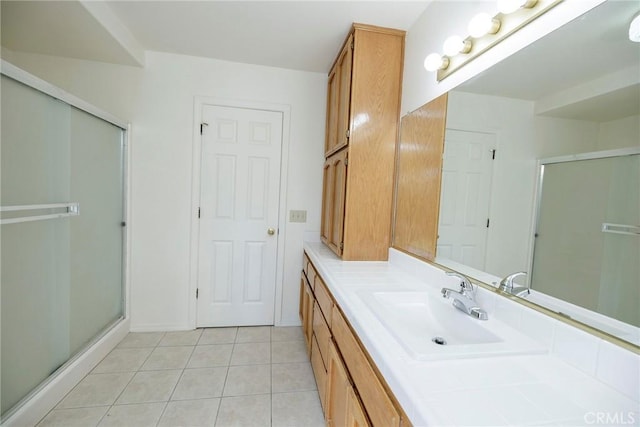 bathroom featuring a shower stall, vanity, and tile patterned flooring