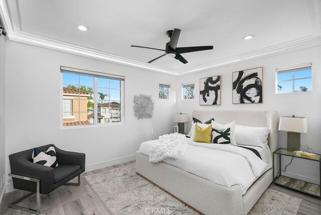 bedroom featuring multiple windows, crown molding, wood finished floors, recessed lighting, and baseboards