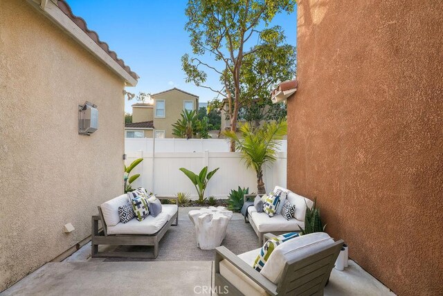 view of patio featuring fence and an outdoor hangout area