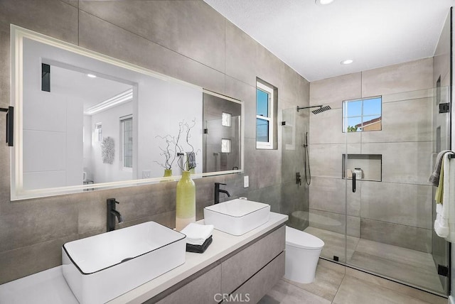 199 Las Flores, Aliso Viejo, CA 92656 - bathroom featuring a shower stall, tile walls, double vanity, toilet, and tile patterned floors