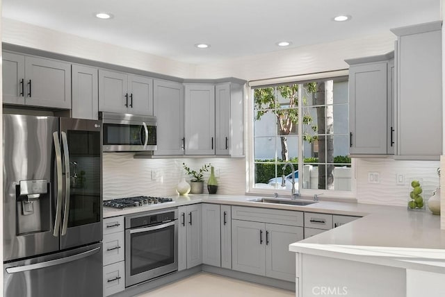 199 Las Flores, Aliso Viejo, CA 92656 - kitchen with appliances with stainless steel finishes, gray cabinetry, a sink, light countertops, and recessed lighting