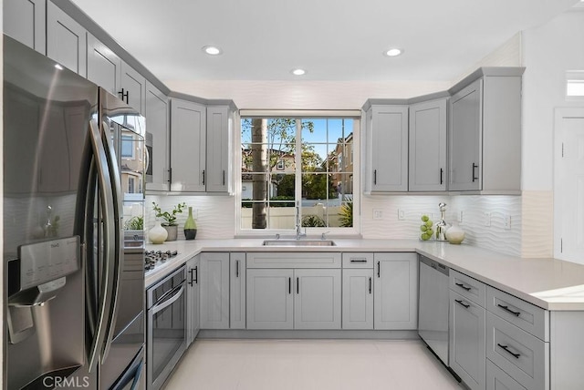 199 Las Flores, Aliso Viejo, CA 92656 - kitchen featuring appliances with stainless steel finishes, gray cabinets, a sink, tasteful backsplash, and recessed lighting