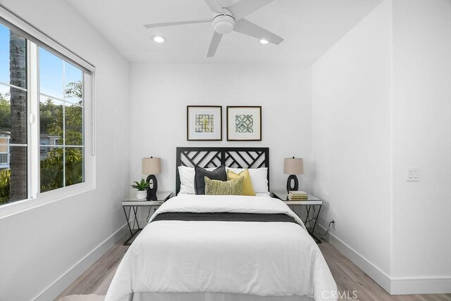 bedroom with wood finished floors, baseboards, recessed lighting, and ceiling fan