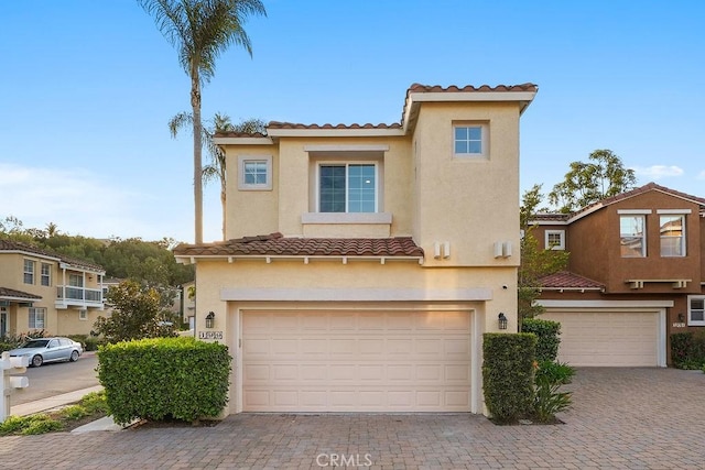 199 Las Flores, Aliso Viejo, CA 92656 - view of front of house featuring a garage, a tile roof, stucco siding, and decorative driveway