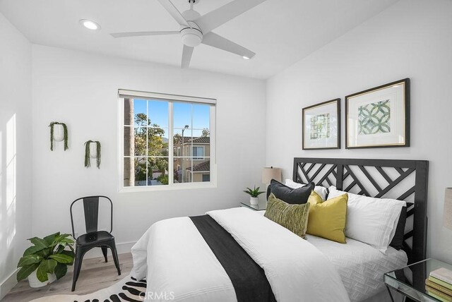 bedroom featuring wood finished floors, baseboards, recessed lighting, and ceiling fan