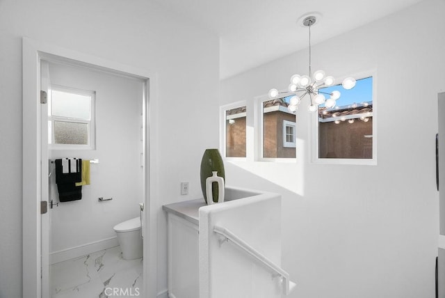 199 Las Flores, Aliso Viejo, CA 92656 - bathroom featuring marble finish floors, toilet, baseboards, and a chandelier