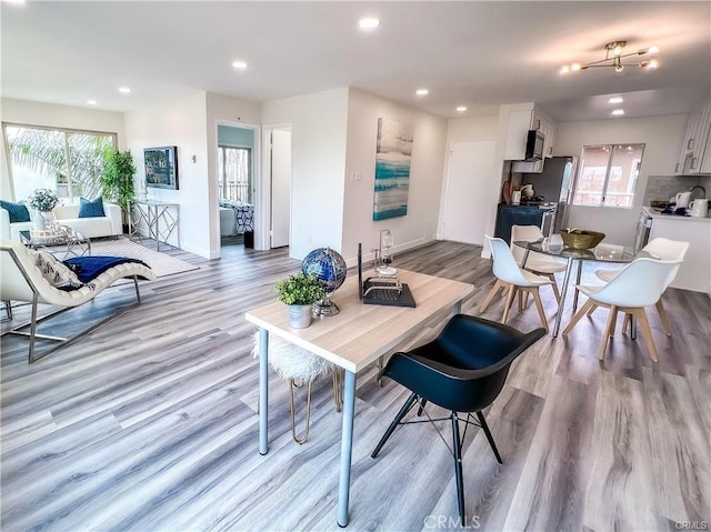 living area with light wood-style floors, recessed lighting, and baseboards