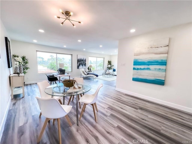 dining space with wood finished floors, recessed lighting, and baseboards