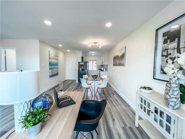 interior space with wood finished floors, recessed lighting, and baseboards