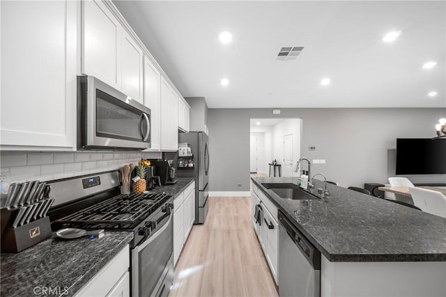 5313 Mariner Ln, Chino, CA 91710 - kitchen featuring an island with sink, visible vents, stainless steel appliances, light wood finished floors, and a sink
