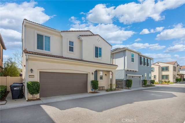 5313 Mariner Ln, Chino, CA 91710 - view of front of house with fence, a residential view, a garage, and stucco siding