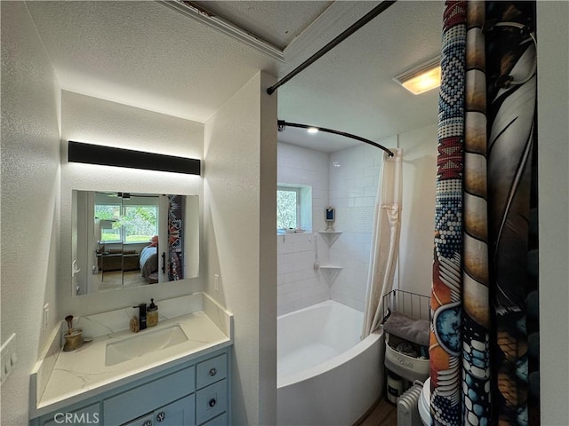 full bathroom featuring shower / bathtub combination with curtain, vanity, a textured ceiling, and a healthy amount of sunlight
