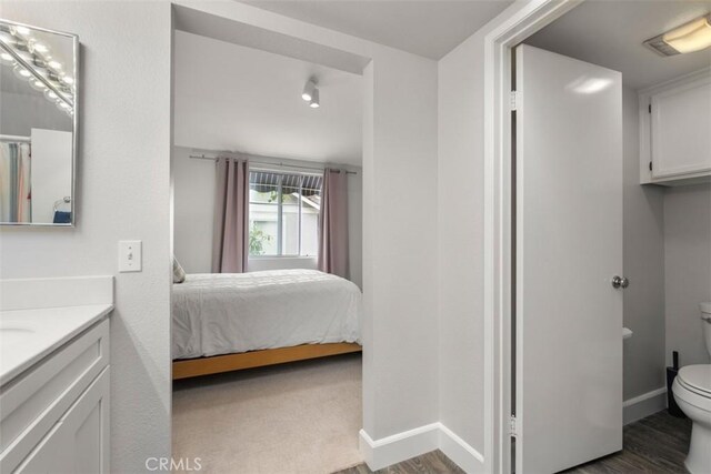 bedroom with wood finished floors and baseboards