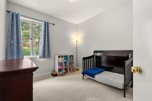 carpeted bedroom with baseboards and multiple windows