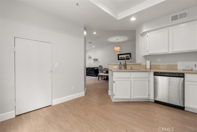 kitchen featuring white cabinets, light wood finished floors, dishwasher, visible vents, and a sink