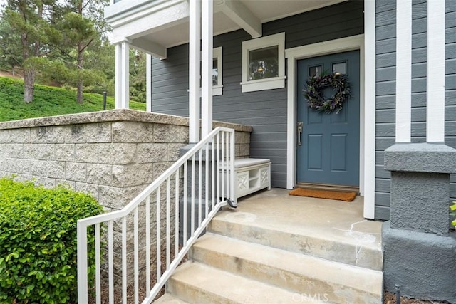 view of exterior entry with a porch