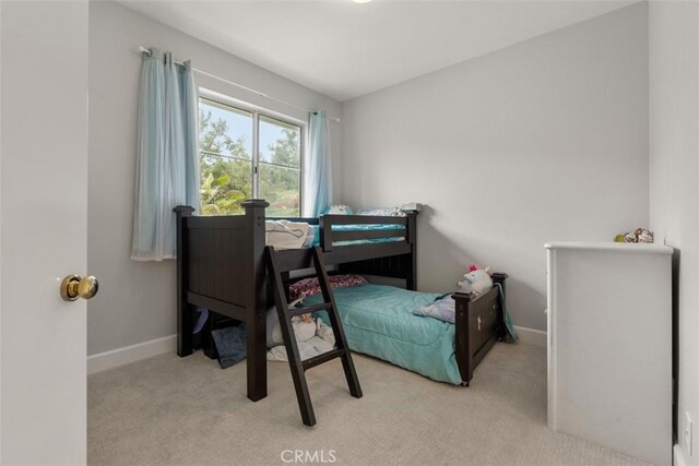 carpeted bedroom featuring baseboards