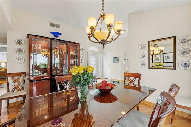 dining room with visible vents, baseboards, and a notable chandelier