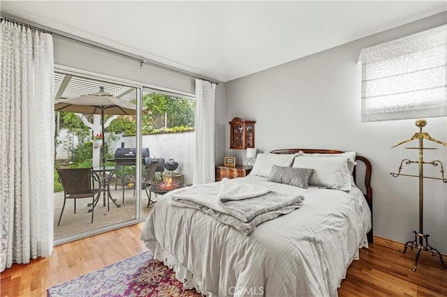 bedroom featuring wood finished floors and access to outside