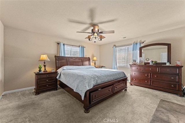 bedroom with light colored carpet, baseboards, and multiple windows