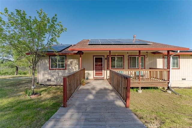 ranch-style house with crawl space, solar panels, a front lawn, and a porch