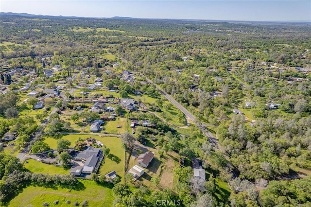 birds eye view of property featuring a forest view
