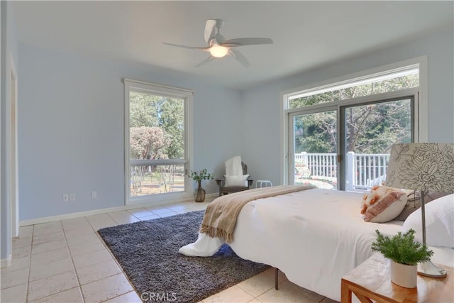 bedroom with multiple windows, tile patterned floors, access to outside, and baseboards