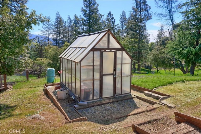 view of greenhouse with a lawn