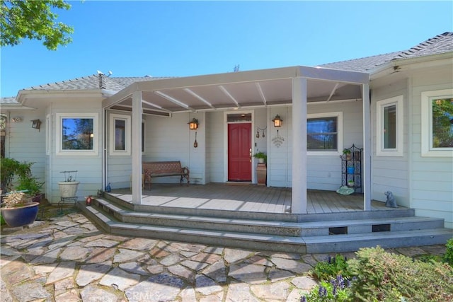 view of exterior entry with covered porch