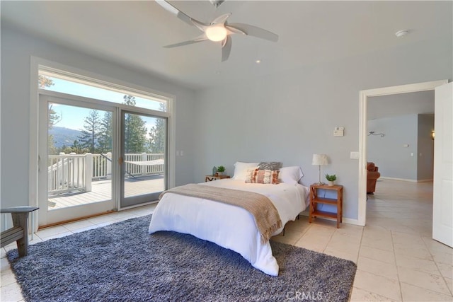 bedroom featuring baseboards, tile patterned flooring, access to exterior, and a ceiling fan