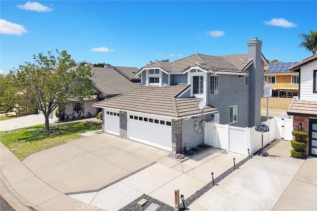 traditional-style home with driveway, a tiled roof, a garage, and fence