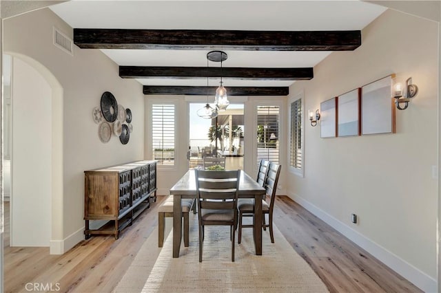 dining area featuring visible vents, baseboards, light wood-type flooring, and a notable chandelier
