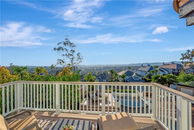 view of wooden balcony with a wooden deck and a residential view