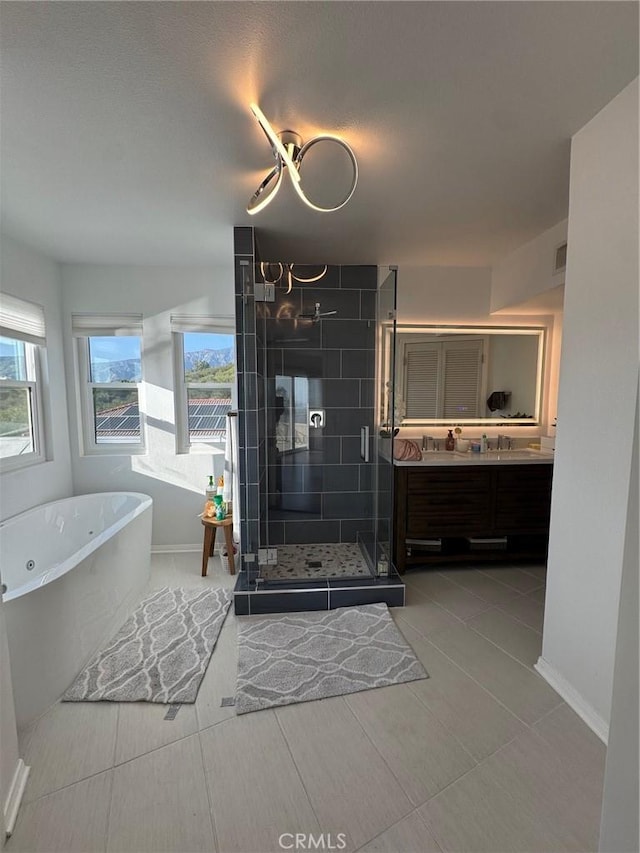 11901 Sunset Ridge Dr, Yucaipa, CA 92399 - bathroom featuring vanity, a soaking tub, a stall shower, and baseboards
