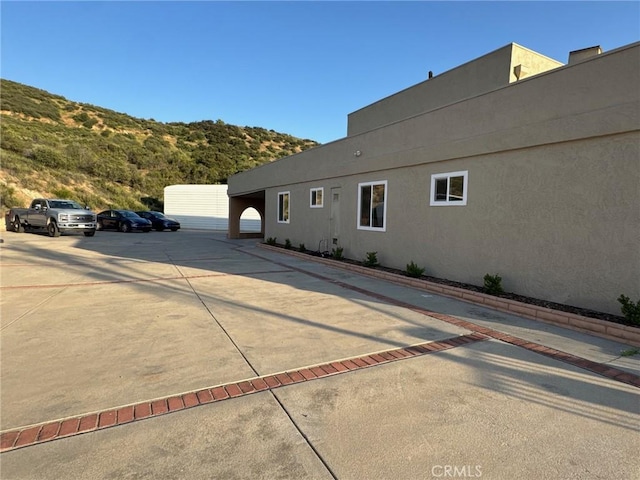 11901 Sunset Ridge Dr, Yucaipa, CA 92399 - view of home's exterior featuring stucco siding and uncovered parking