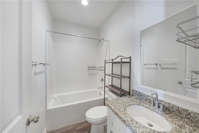 full bathroom featuring washtub / shower combination, vanity, toilet, and wood finished floors