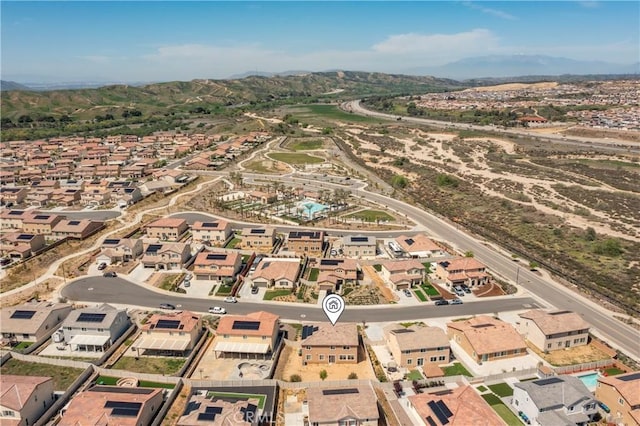 drone / aerial view featuring a residential view and a mountain view