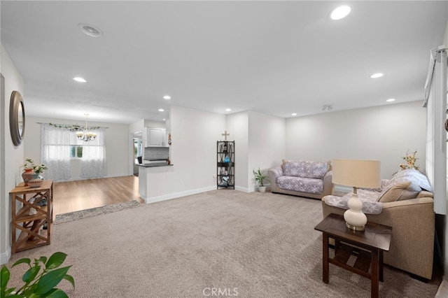 29423 Pebble Beach Dr, Menifee, CA 92586 - living room featuring recessed lighting, light colored carpet, and a chandelier